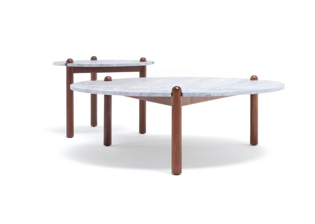 Two Caprera Coffee Tables. White round top with three sleek brown legs on a white background.