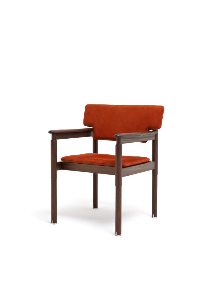 Vieste Chair: Wooden chair with a red cushioned seat and slatted backrest on a white background.