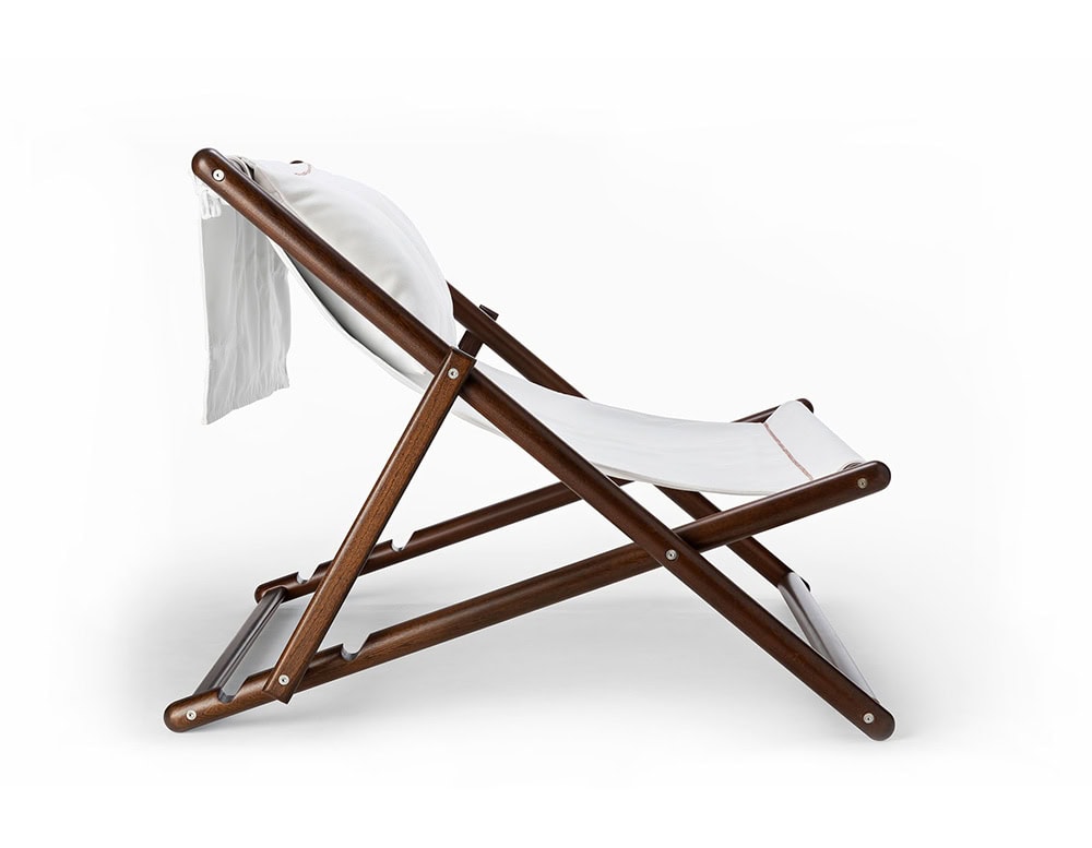 Paraggi chair with crossed legs made of brown wood, upholstered in white fabric on a white background.