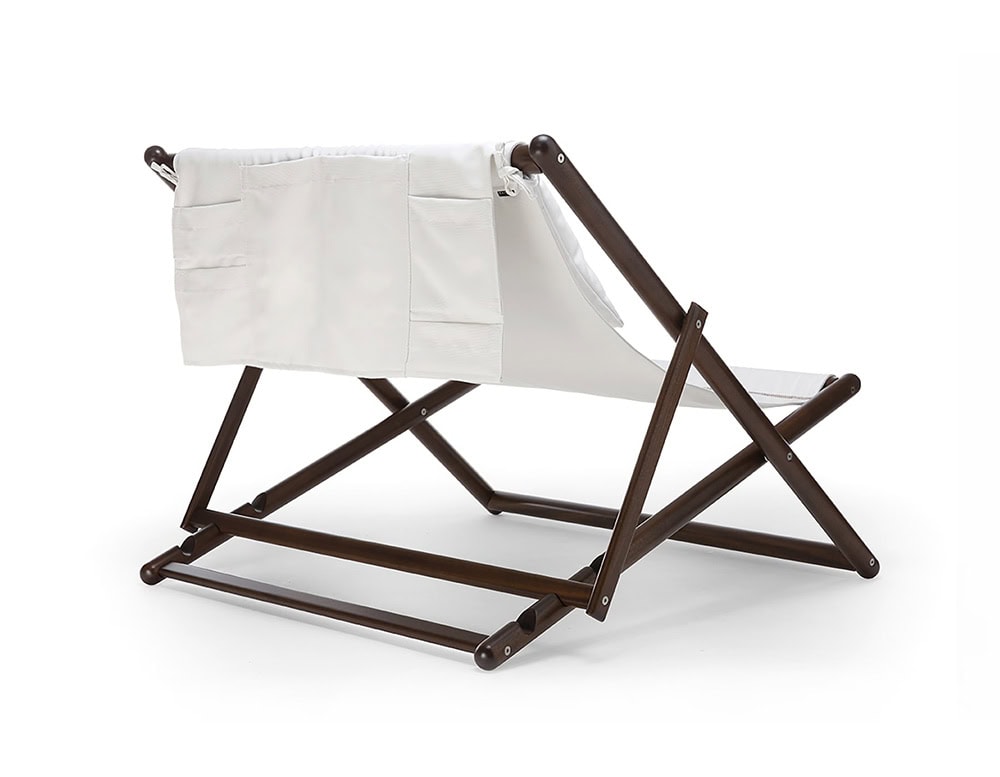 Paraggi chair with crossed legs made of brown wood, upholstered in white fabric on a white background.