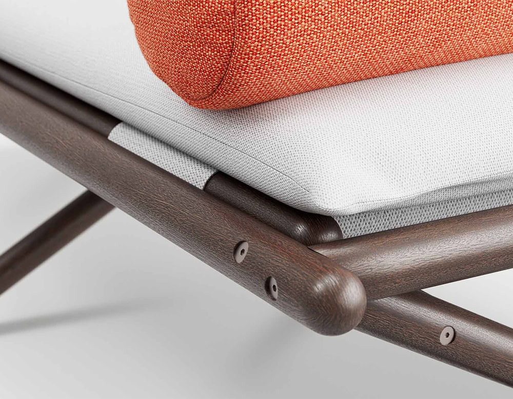 Closeup of Paraggi Sun Lounger. Structure in brown wood with cushion in white and orange on a white background.