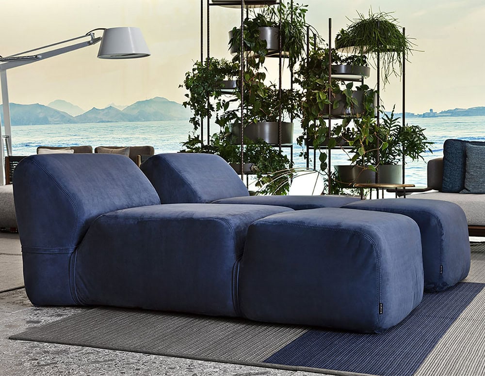 Two Soft Chaise Long covered in blue fabric in a living room.