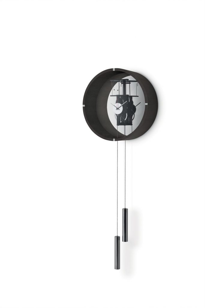 Black Tic Tac 14 pendulum clock with a sleek design, featuring a round face and slender pendulum on a white background.