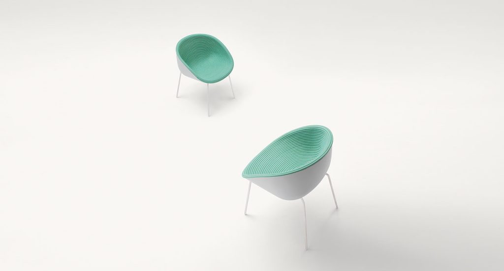 Two Amable Outdoor Chairs, four legs of white steel, white molded polyethylene shell and green rope cord cover on a white background.