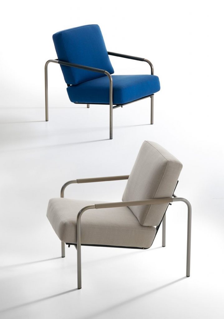 Two Susanna lounge chairs with a sleek metal frame. One with gray and one with blue cushioned seat and backrest.
