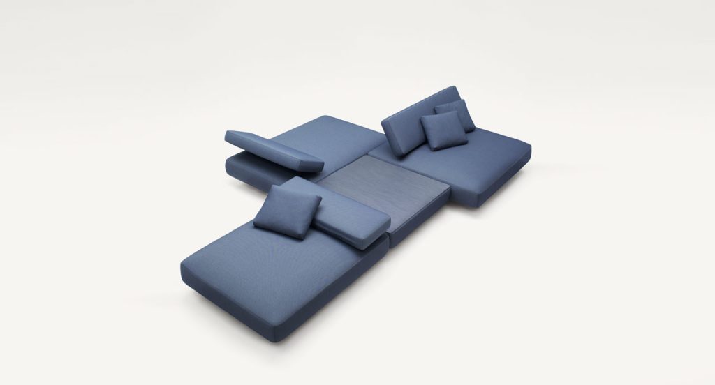 Agio Modular sofa composed of large platforms, backrest can be adjusted, all upholstered in blue fabric on a white background.