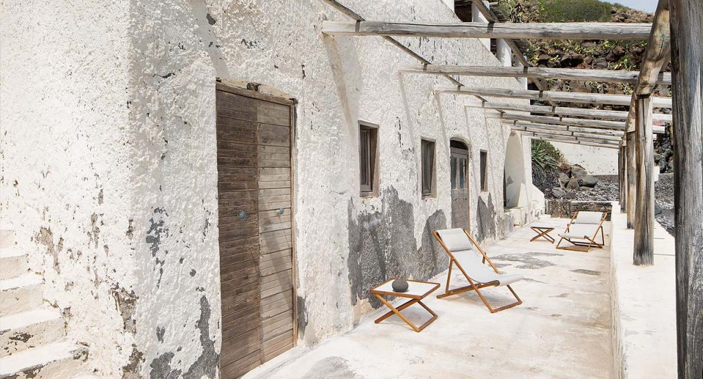 Two Portofino Outdoor Deck Chairs, structure in natural heartwood, upholstery in white fabrics in a terrace.