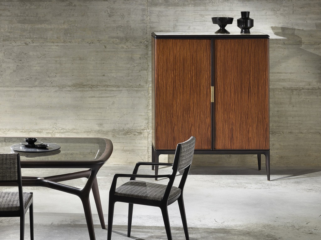 Furniture made with a walnut wood base and steel legs in a brown tone and finished in black leather