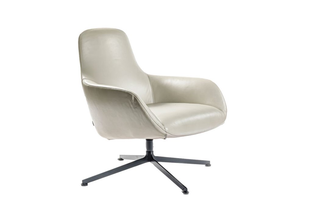 Angled view of Kent armchair in front of a white background