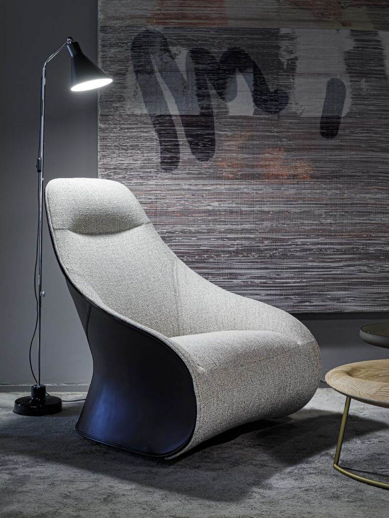 Armchair with mixed upholstery on a 360-degree swivel base in a tone of white with brown