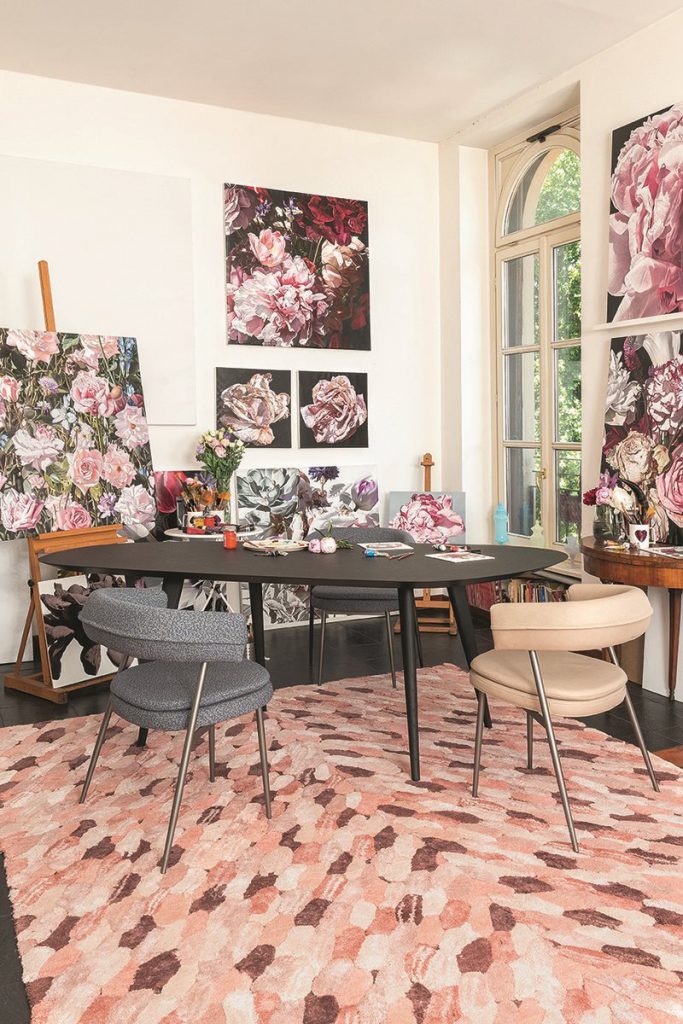 two armchairs made of steel foam and upholstered in gray and beige leather in a living room