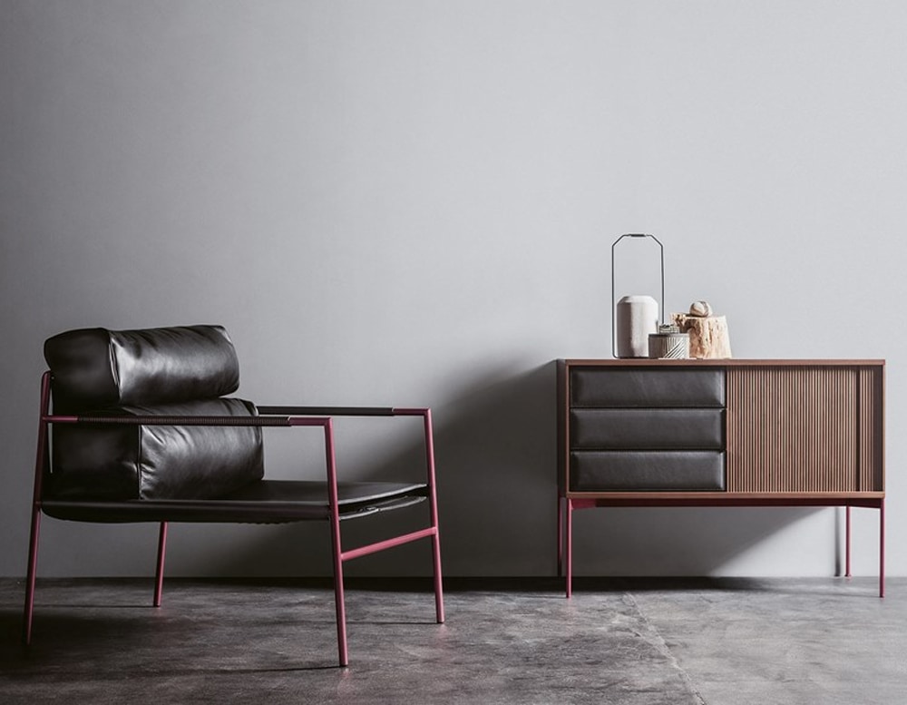 armchair made of black steel base and red finishes upholstered in black leather