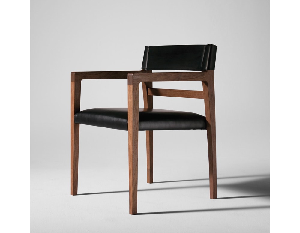 dining chair made of black leather strips and wooden base on a gray background