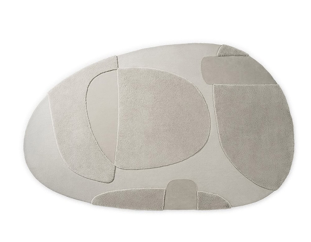 Handmade rug with an oval design and spots in a light and dark gray tone