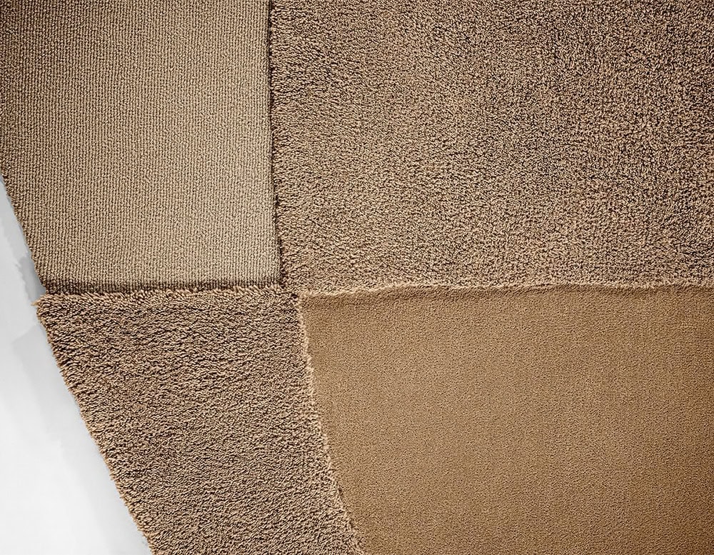 rug made from a fabric base in a coffee color tone in different shades