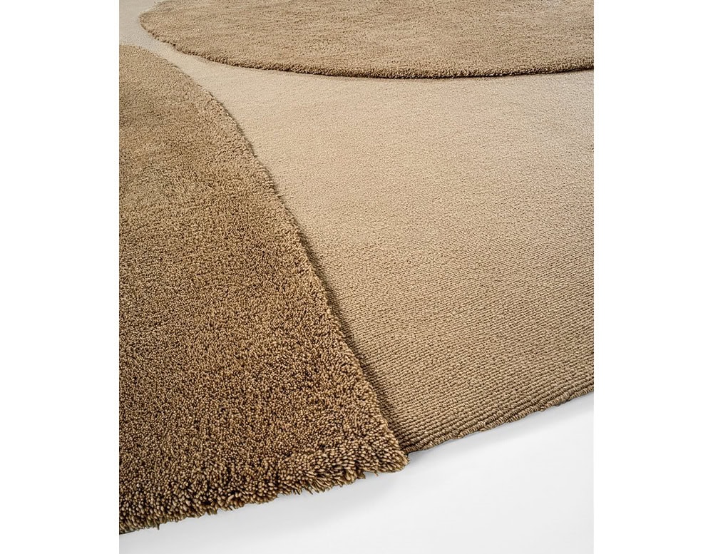 rug made from a fabric base in a coffee color tone in different shades on a white background