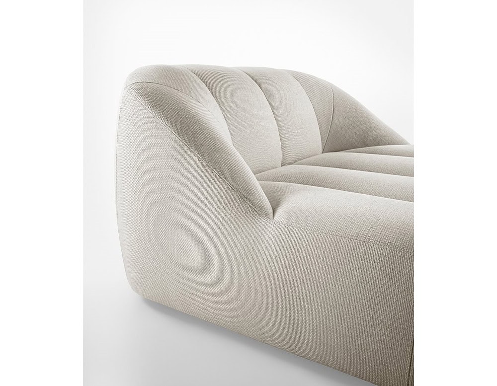 Armchair made of polyurethane foam, wooden base and upholstered in white leather on a white background