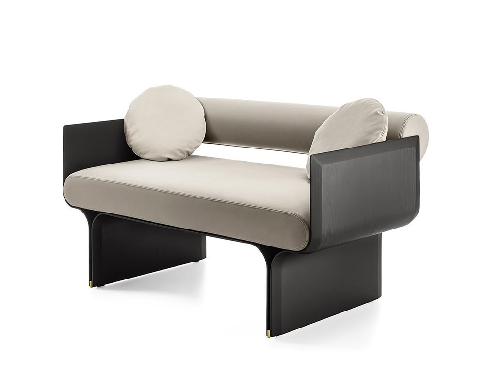 small curved sofa made of black-stained ash wood base and upholstered in white fabric