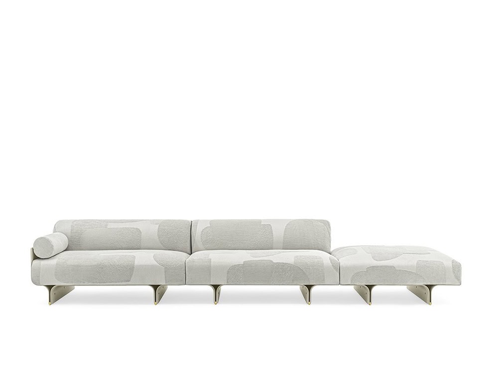 sofa made of curved ash wood base and upholstered in white fabric with a design in gray stains