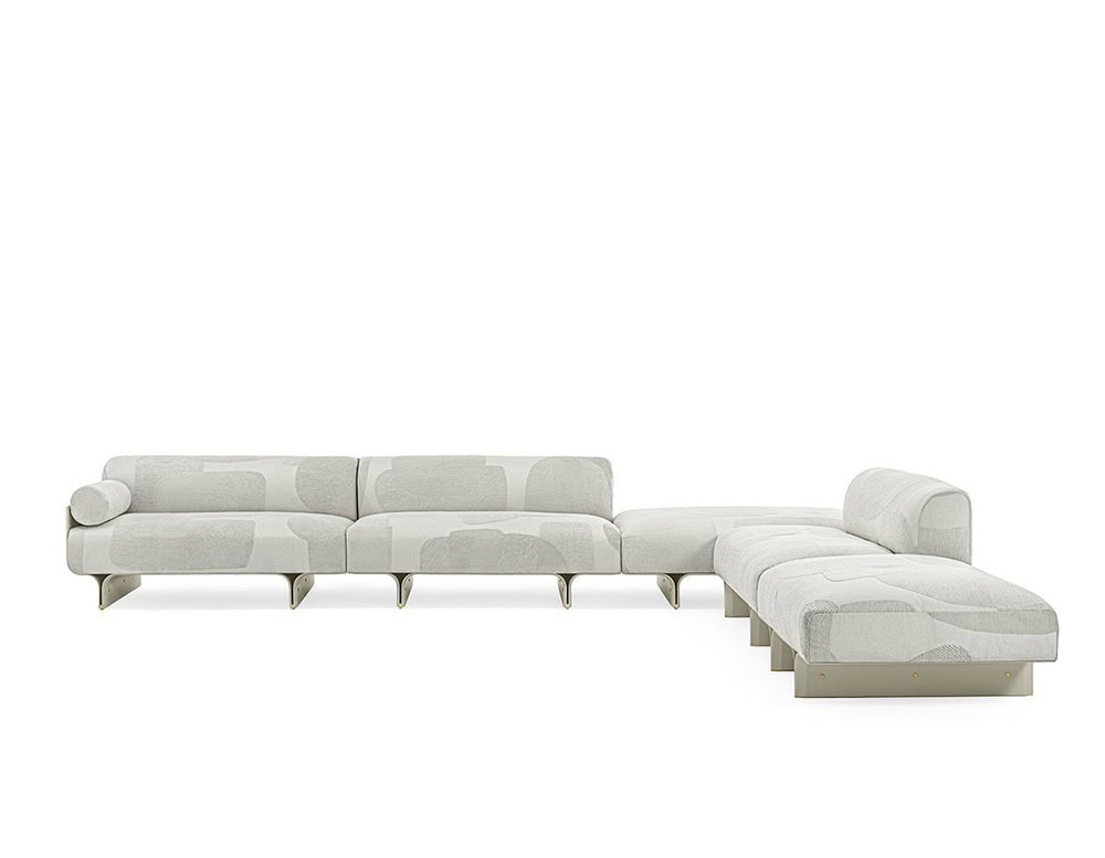 sofa made of curved ash wood base and upholstered in white fabric with a design in gray stains