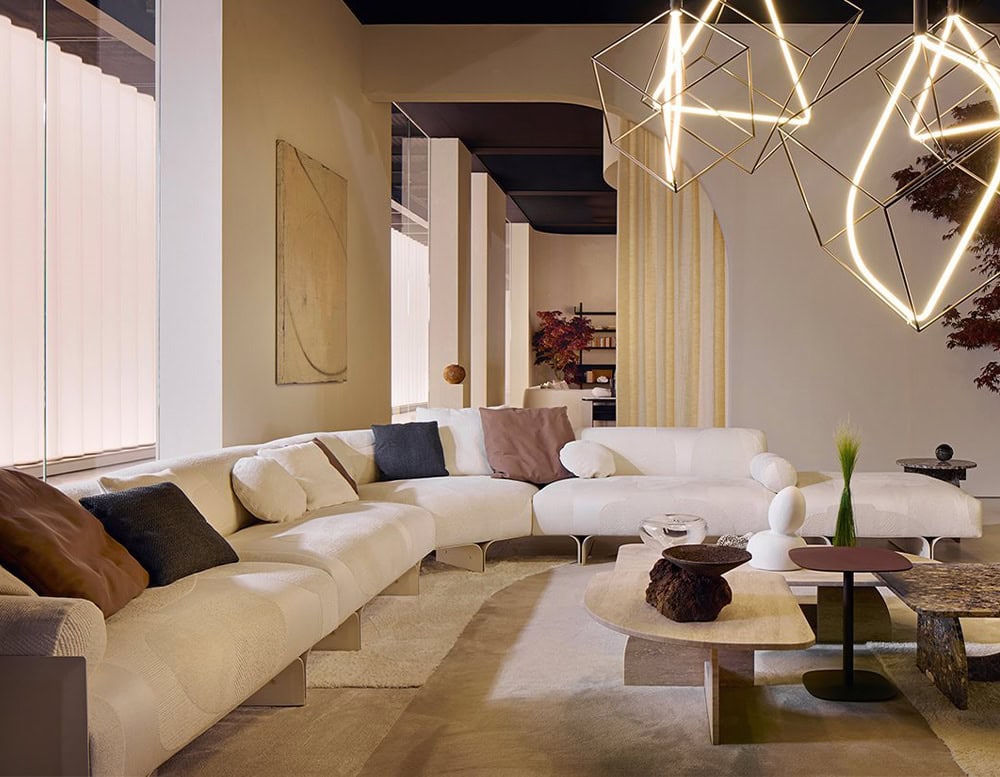 Curved sofa made of brown ash wood base and white fabric with gray in a living room