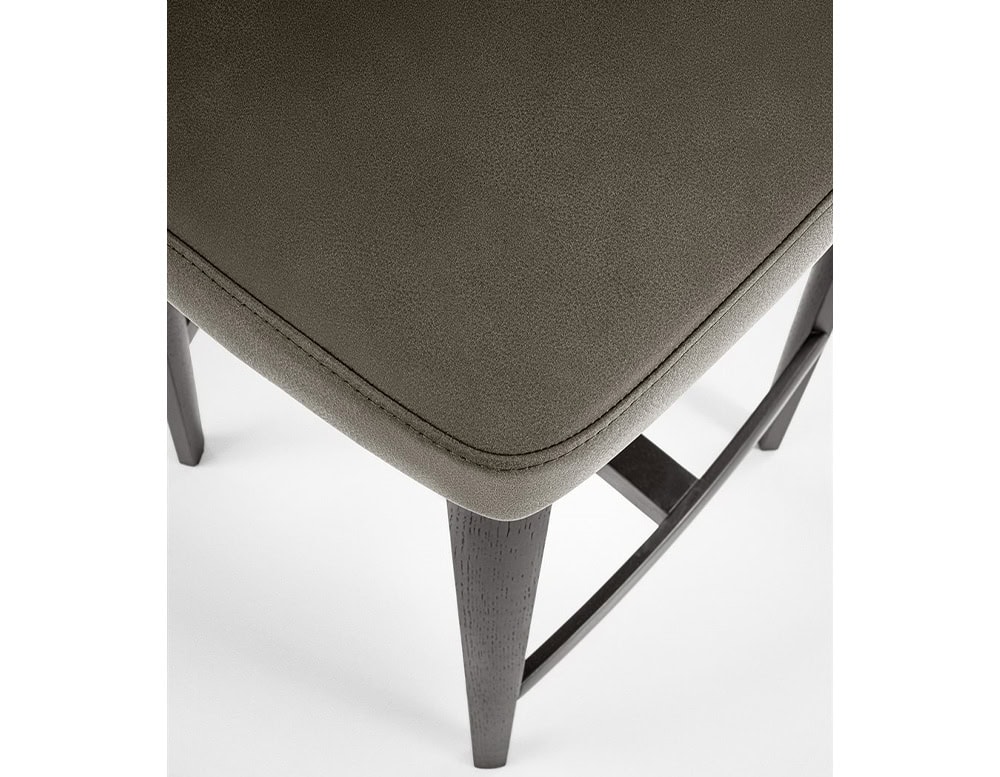 high stool made of matte black lacquered wood base and upholstered in brown fabric