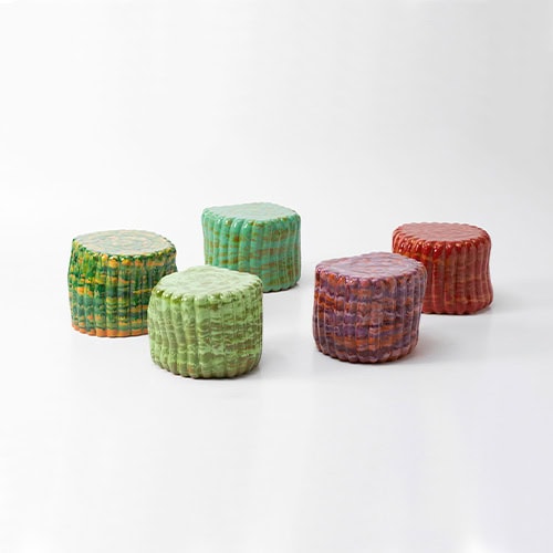 5 side tables made in anemone in a color tone of different greens and reds on a white background