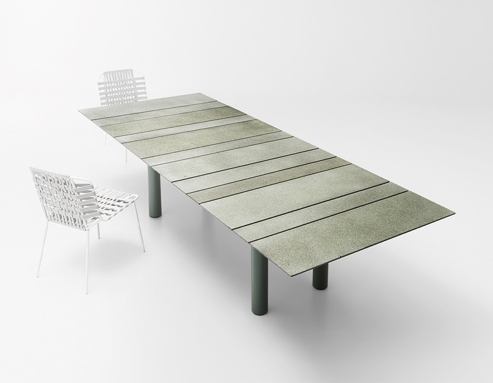 Rectangular dining table made of stainless steel handle and top in different elements in a varnished gray tone