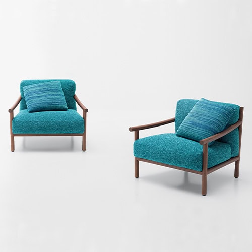 two armchairs made of heartwood and upholstered in removable fabric in an aquamarine blue tone