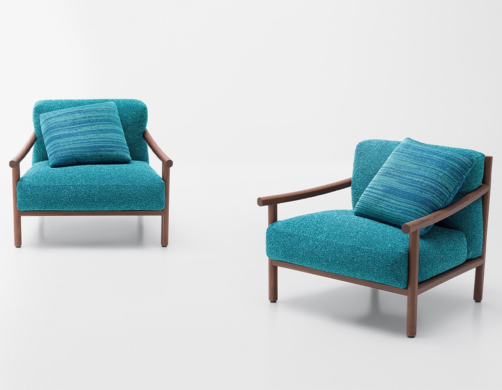 two armchairs made of heartwood and upholstered in removable fabric in an aquamarine blue tone