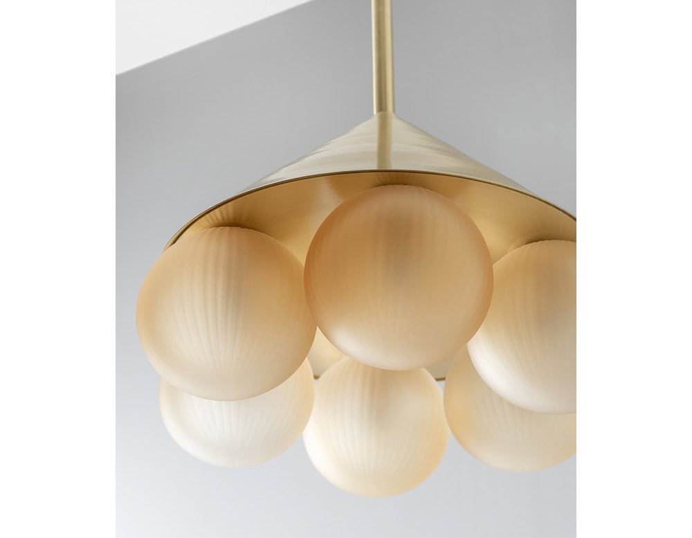 ring lamp with spheres made of glass in a white and gold tone on a white background