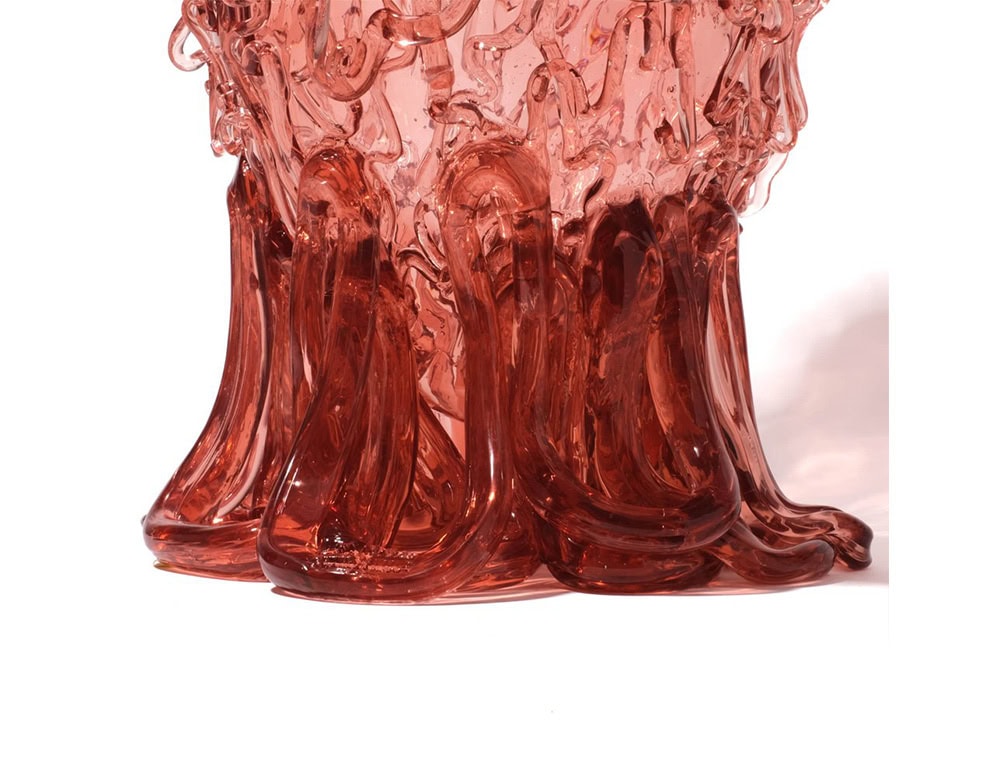 Bottom part of Medusa Vase Pink in translucent with irregular pattern on a white background.