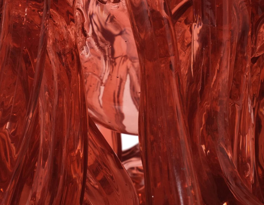 Closeup of of Medusa Vase Pink in translucent with irregular pattern on a white background.