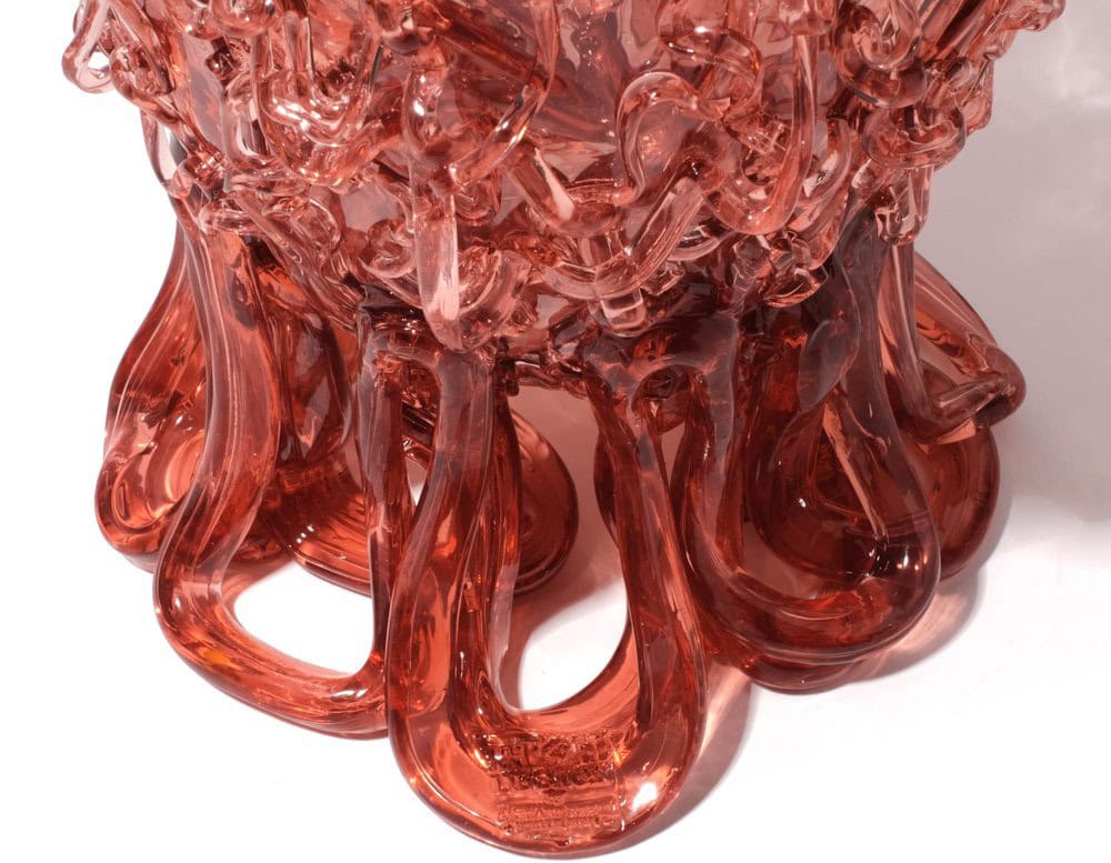 Bottom part of Medusa Vase Pink in translucent with irregular pattern on a white background.