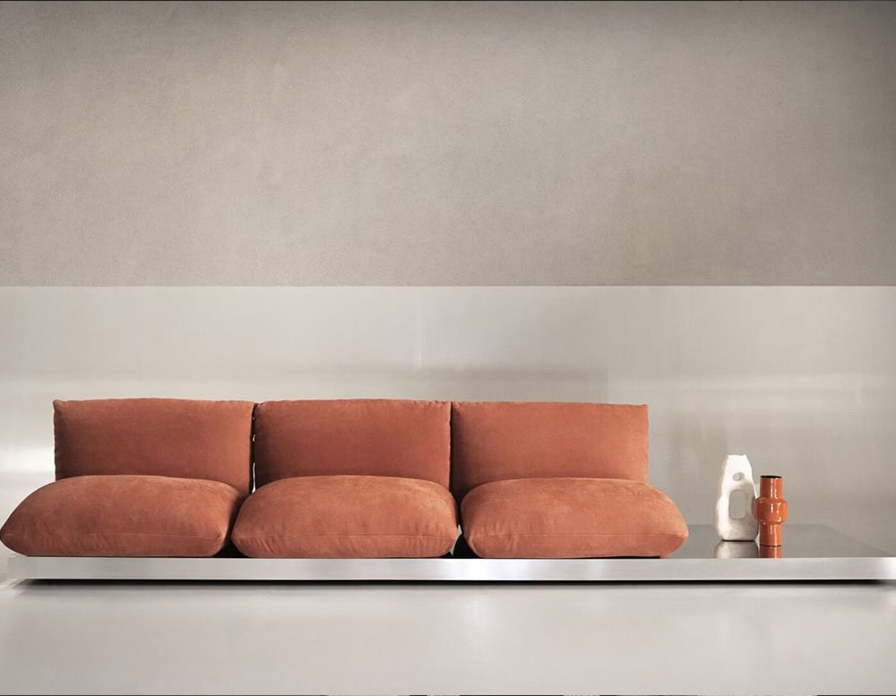 Three seater Aura sofa in brown leather on a white background.