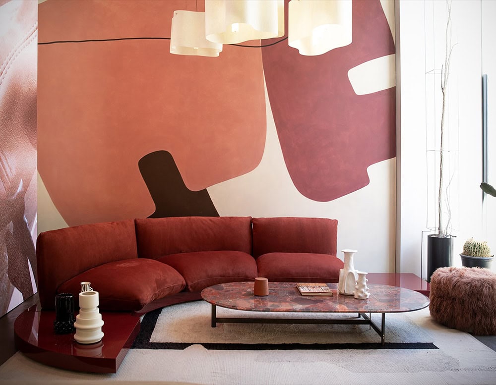 Aura brown sofa positioned against a textured wall in a living room.