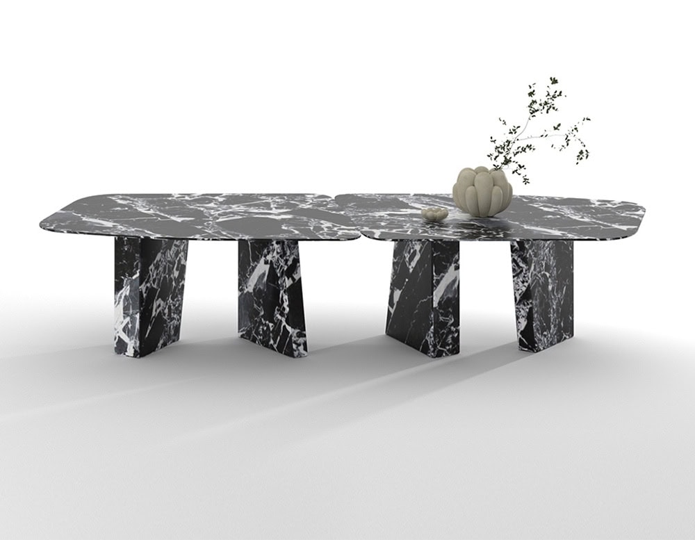 Oval Paramount dining table in black marble with white lines and four legs, set against a white background.