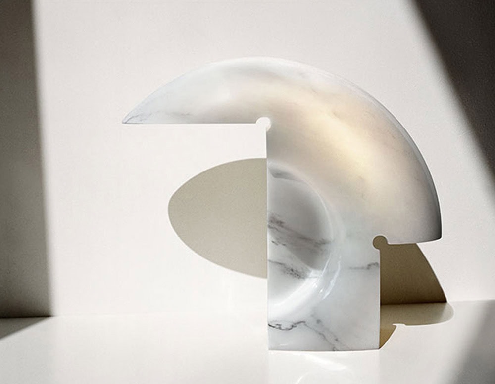 Flos Biagio lamp with irregular shape in silver on a white background.