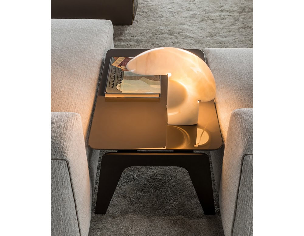 Flos Biagio lamp with irregular shape in silver on a table.