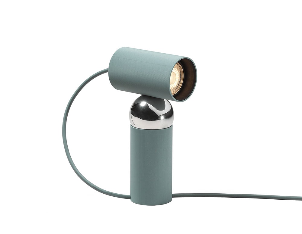 Flos Bilboquet lamp with cylindrical shape in green on a white background.