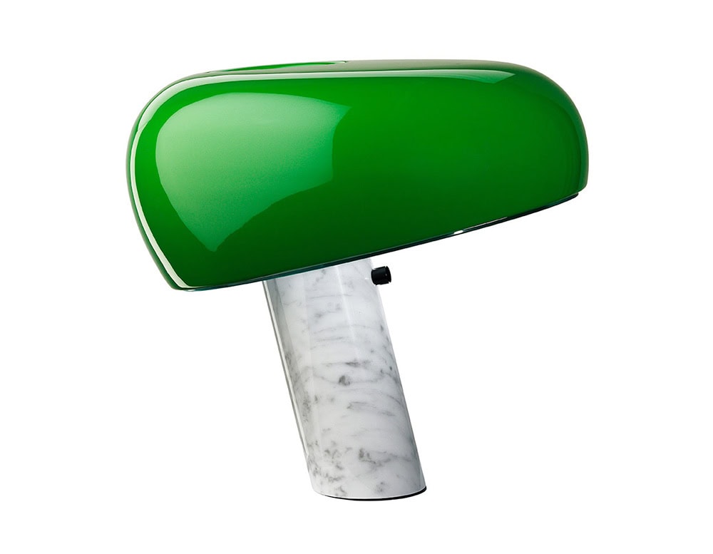 Flos Snoopy lamp. Green top in head dog like shape and white base on a white background.